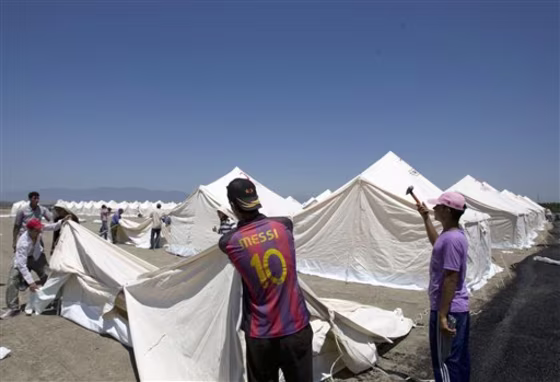 Turkish Red Crescent workers pitch tents Friday&nbsp;in a new camp that can receive up to 15,000 people for possible Syrian refugees in the Turkish town of Apaydin in Hatay province, Turkey.